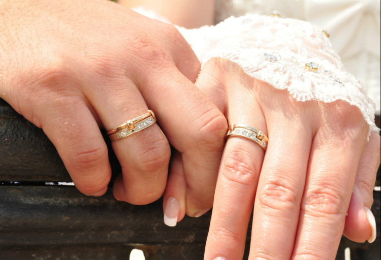 Женское обручальное кольцо на пальце